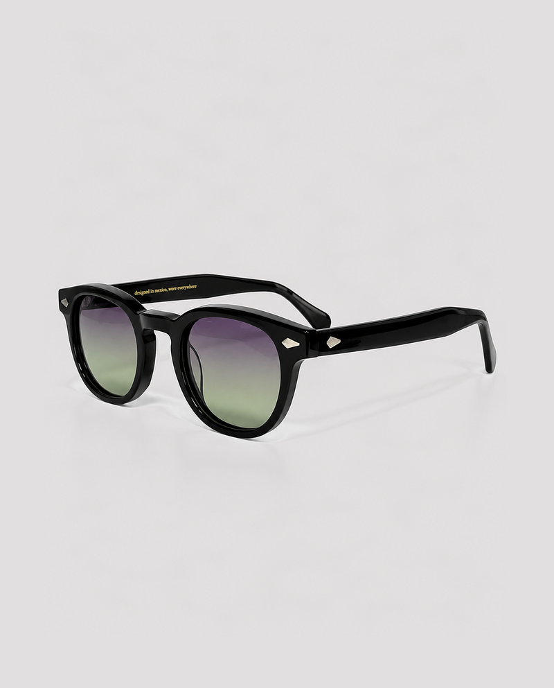 lentes de sol freddi jungle, acetato negro con lente degradado morado a verde, vista tres cuartos